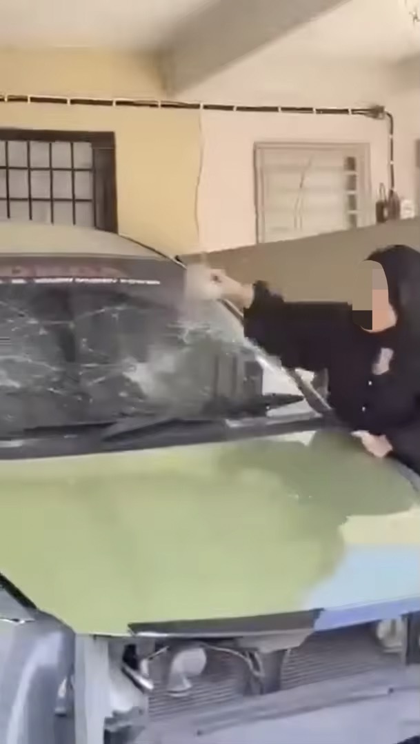 M'sian woman wrecks car with a brick