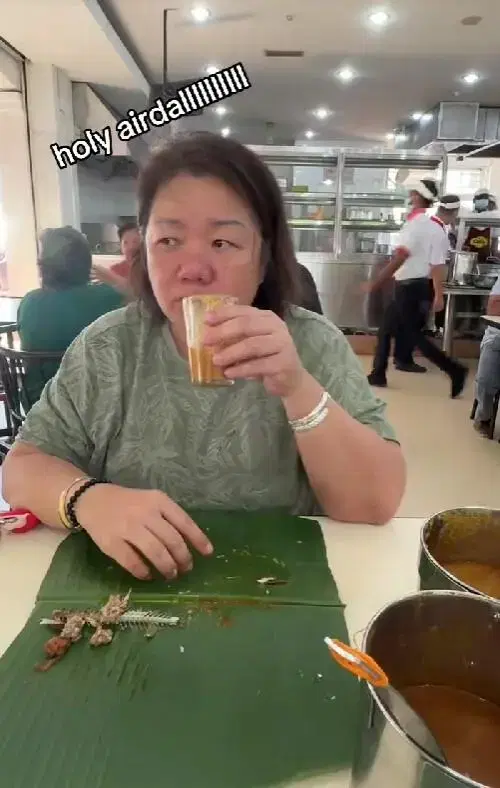 msian woman drinking dhal in the cup