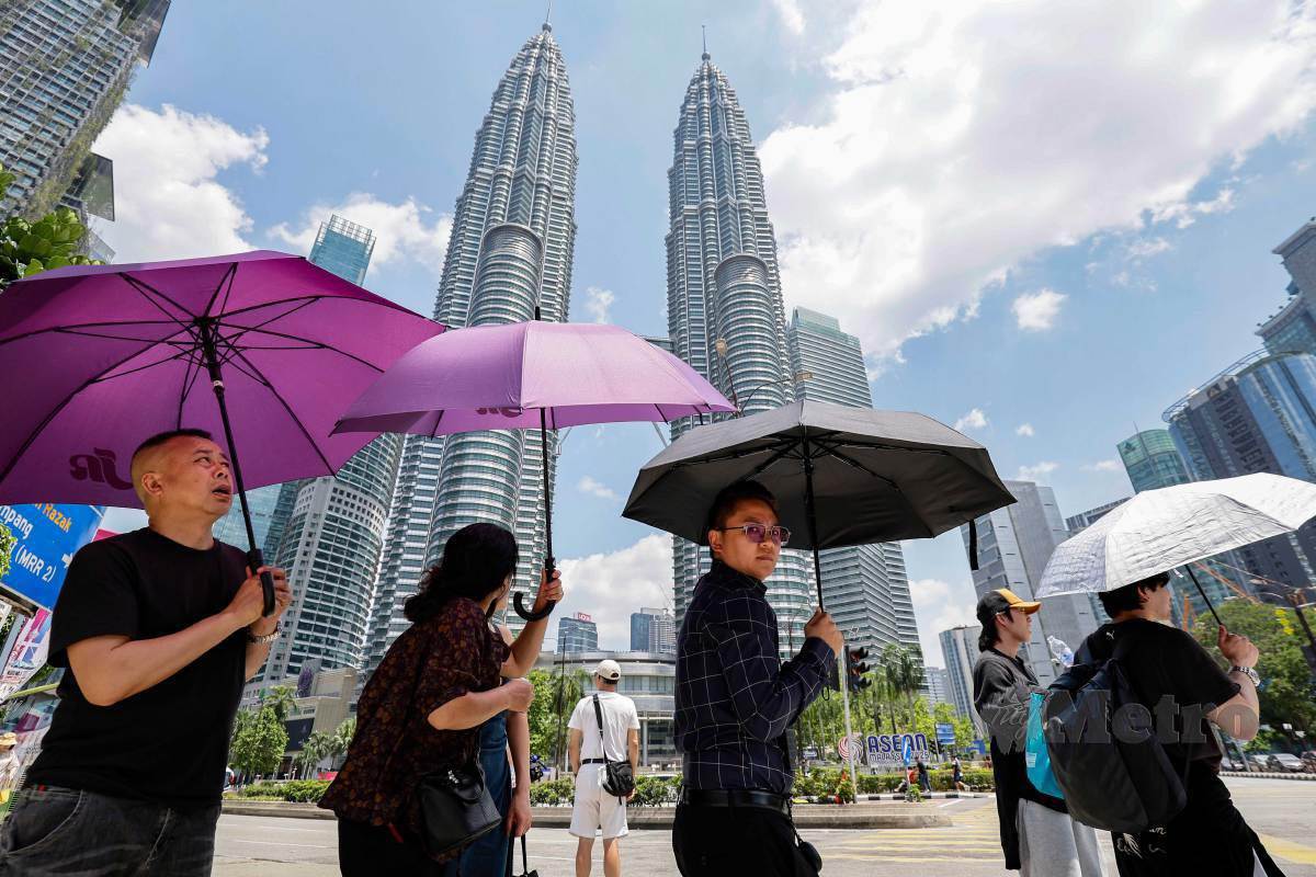 M'sians holding umbrellas in hot weather