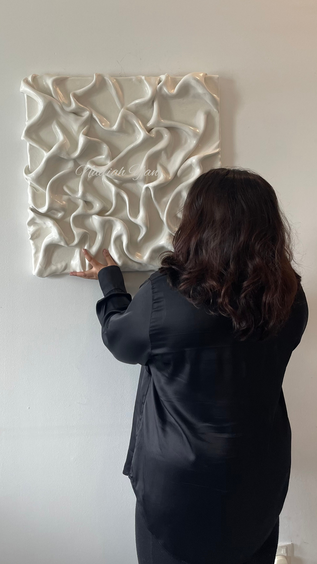 Nadiah yan, looking at her abstract painting