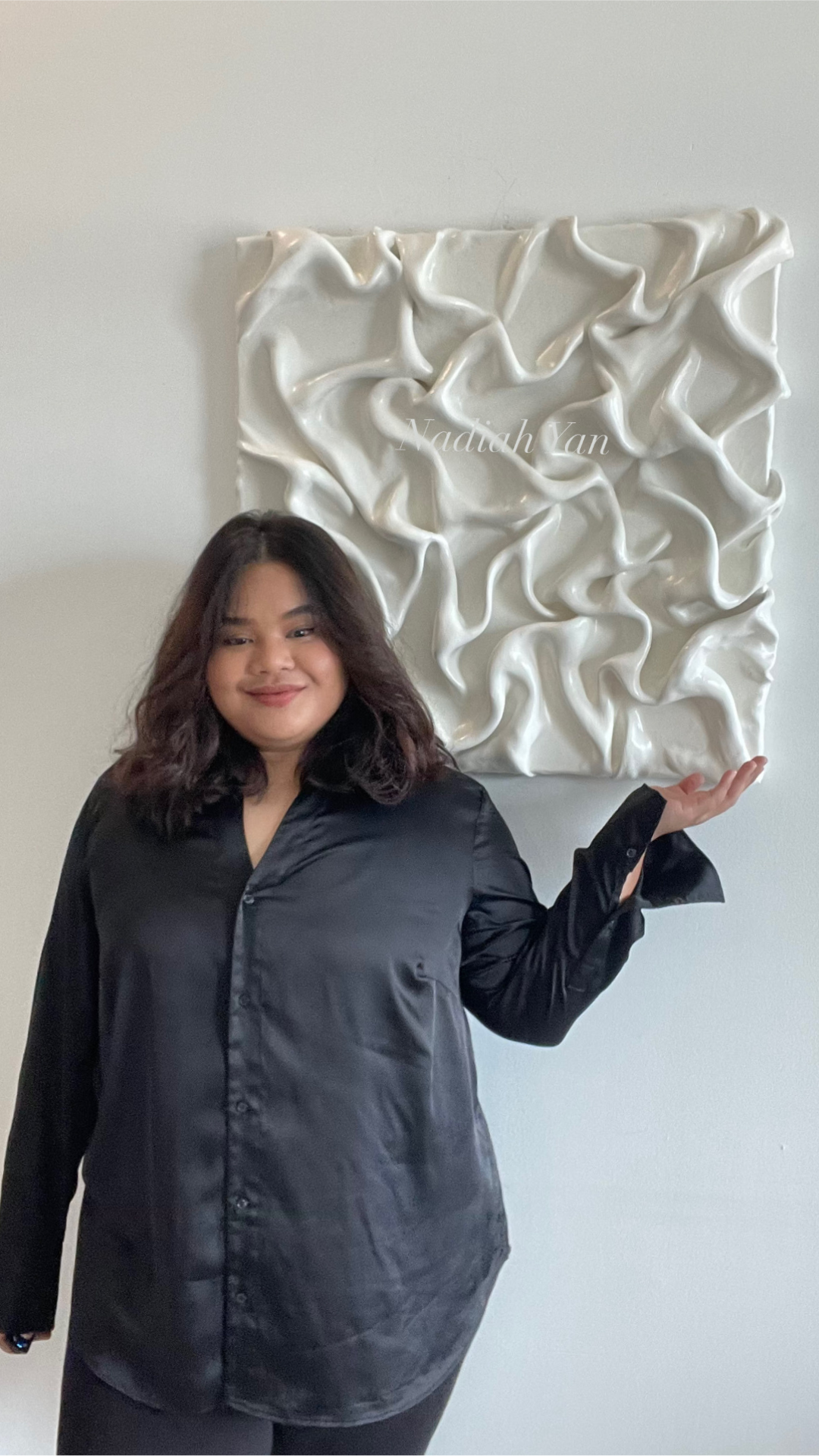 Nadiah yan, with one of her abstract paintings
