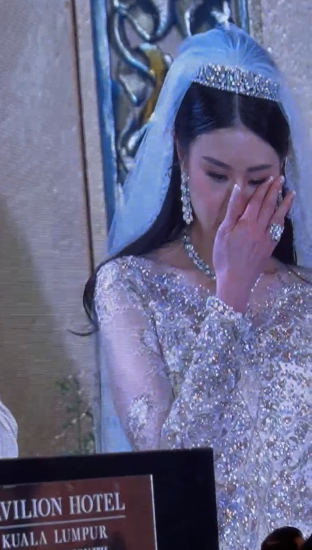 Nikola wiping tears away on wedding