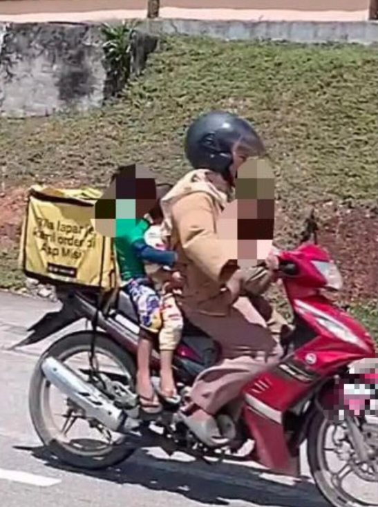 Noryani Syakira Yaakob with her kids at work