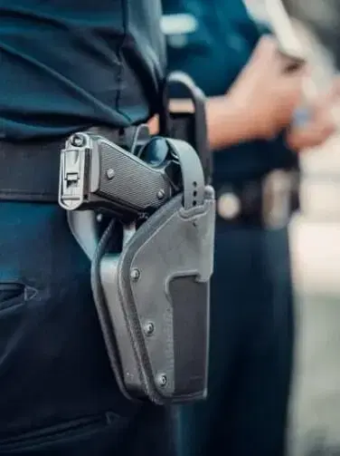 Officer carrying gun with holster