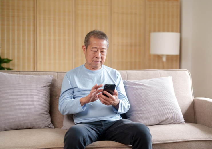 old Asian man using phone