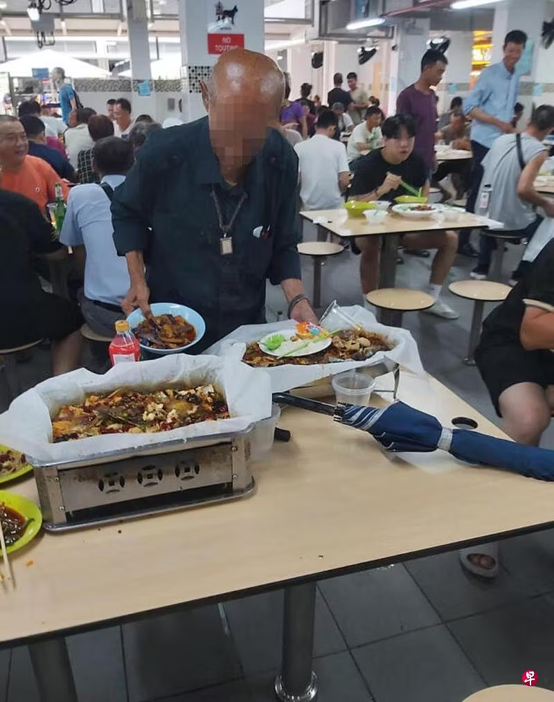 Old man gathering uneaten food at food court