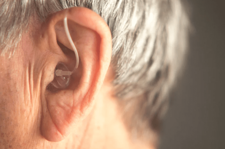 Old man wearing hearing aid