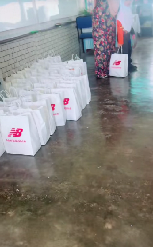 one msian student is holding a bag of new balance shoe gifted by a parent