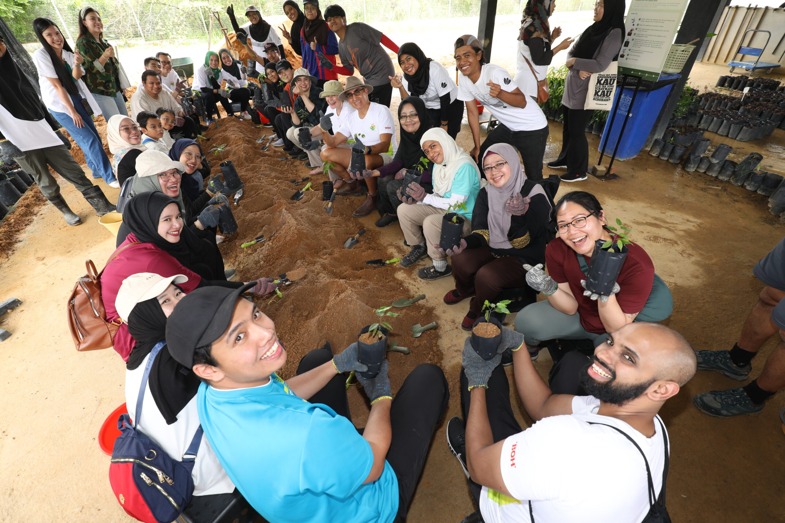 Participants are all smiles with their transplanted seedlings