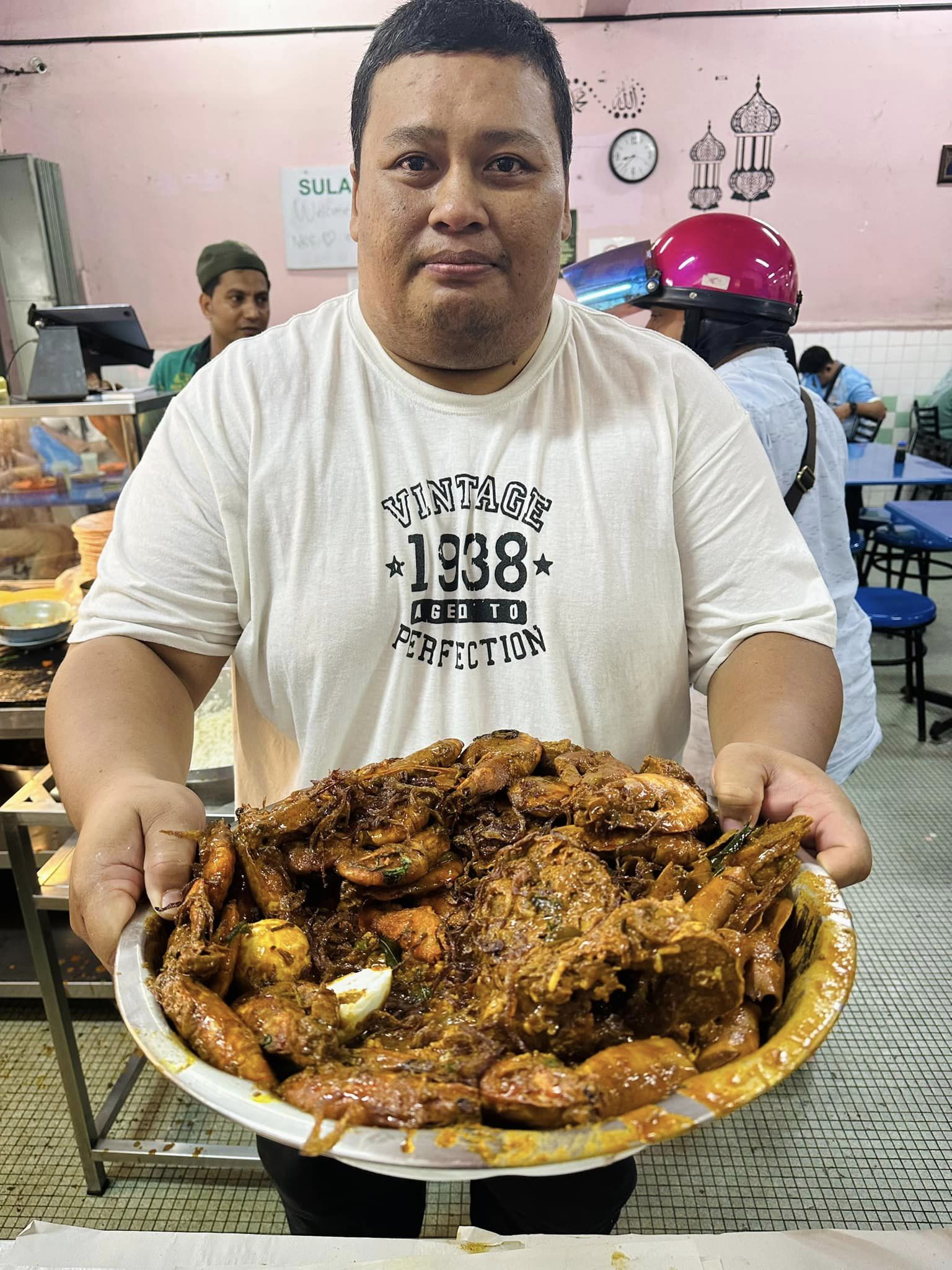 Penang man with a plate of nasi kandar