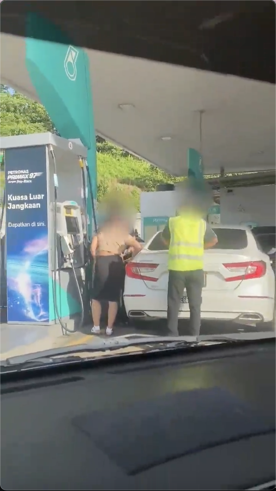 Petrol station worker helping couple with thai car pump ron95 petrol