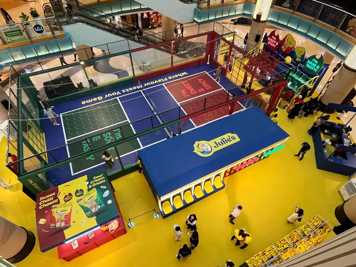 A wide view of Julies roadshow, where flavour meets your game, featuring a pickleball court as the centrepiece at Sunway Pyramid mall