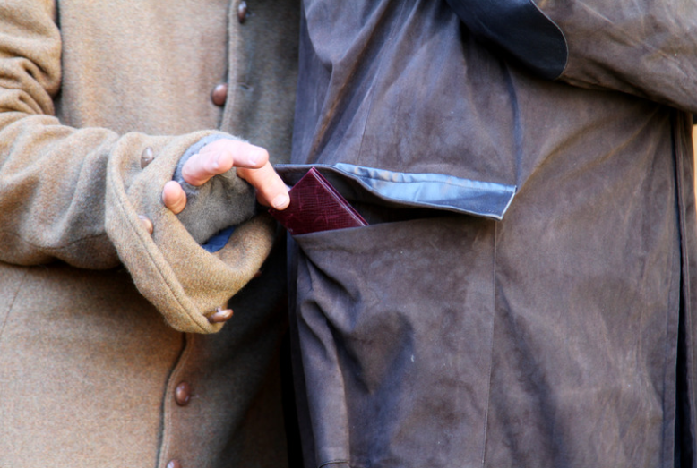 Pickpocket stealing a wallet