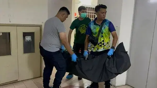Police carry out dead body from Penang flat
