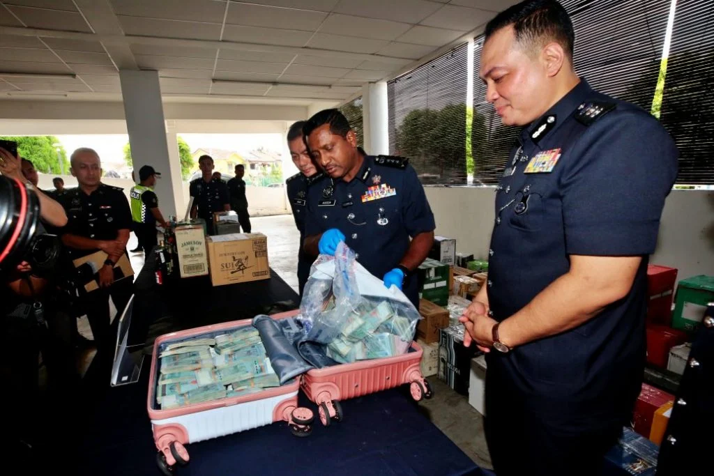 Selangor police chief datuk hussein omar khan inspecting suitcase