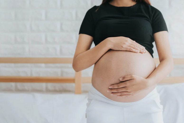 Pregnant woman holding her belly