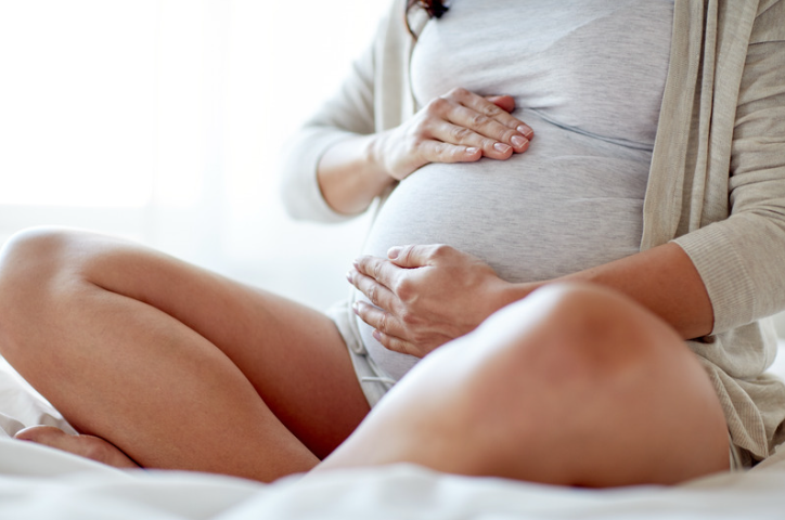 Pregnant woman holding her stomach