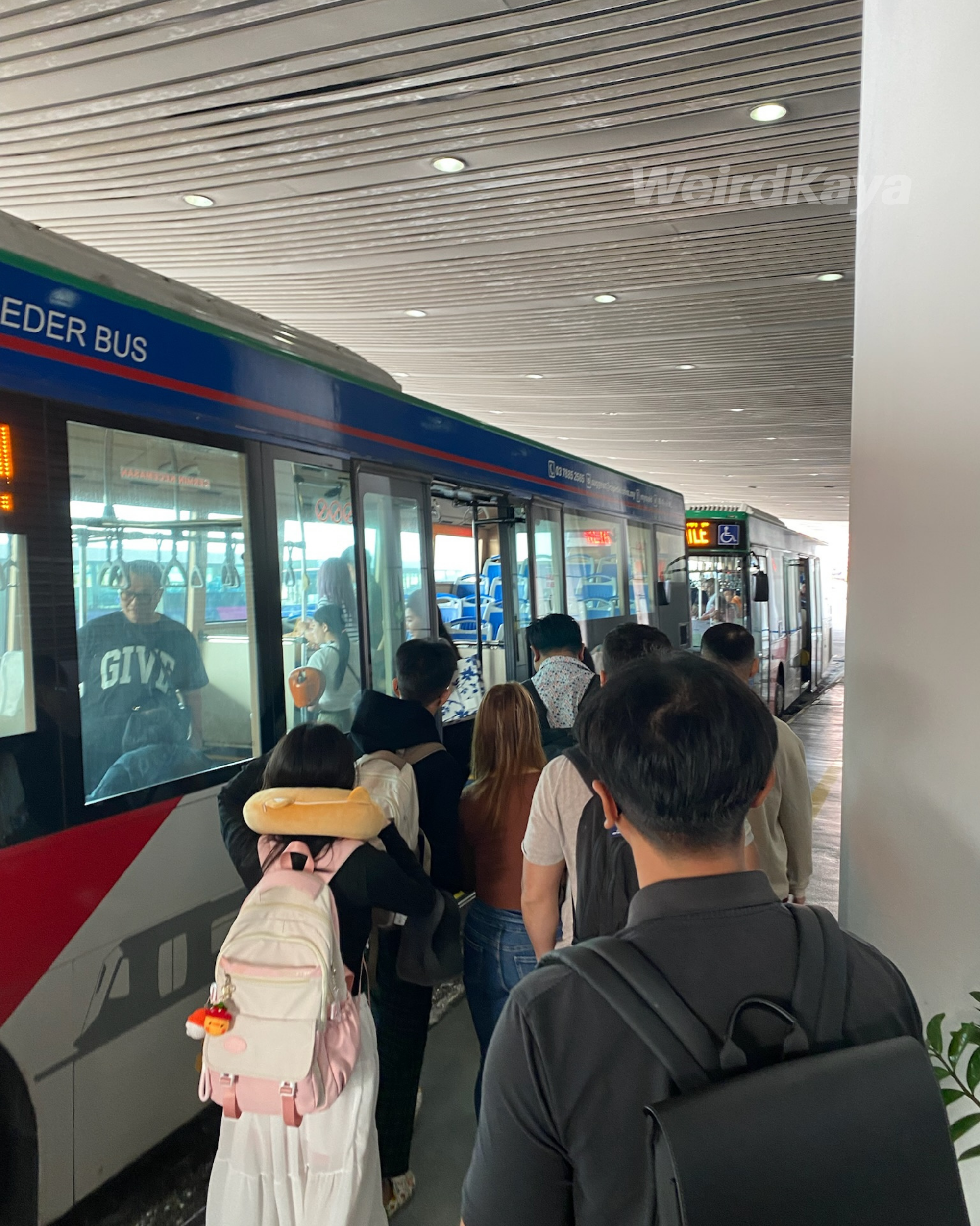 Queuing for airport boarding feeder bus at klia airport lobby departures