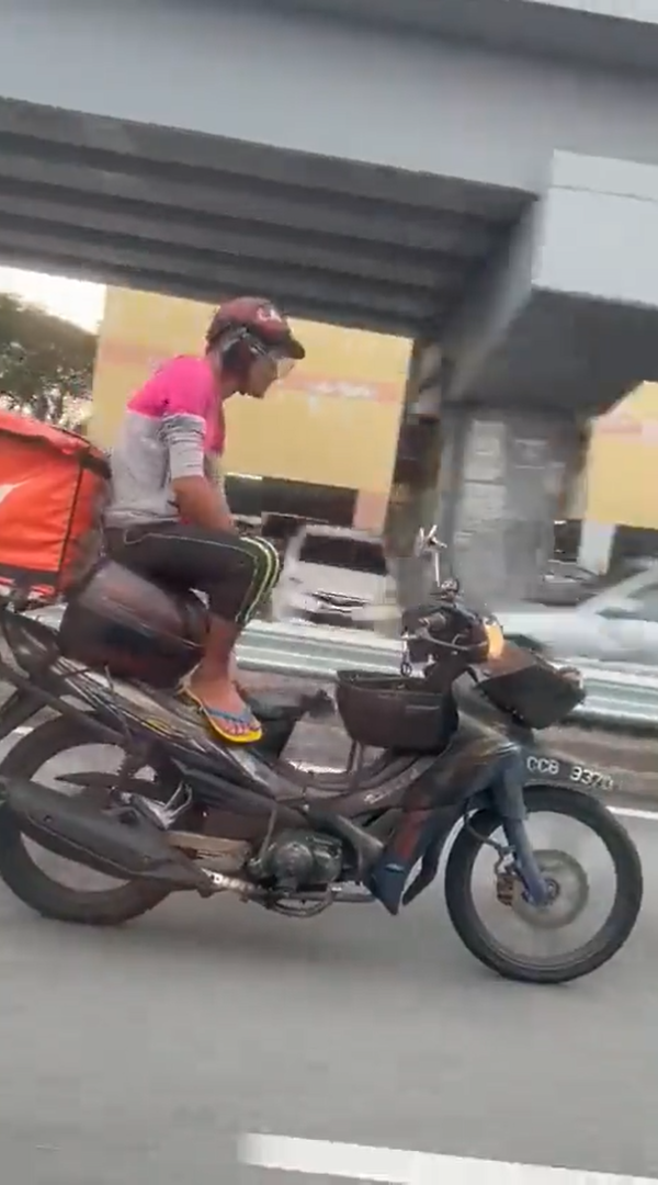 M'sian delivery rider seen riding motorbike with no hands, nabbed by police for endangering public safety