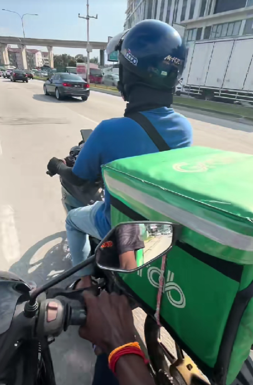 rider pushing another rider's motorbike
