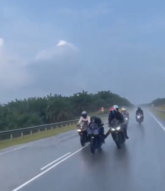 Riders escorting motorbike in rain (2)