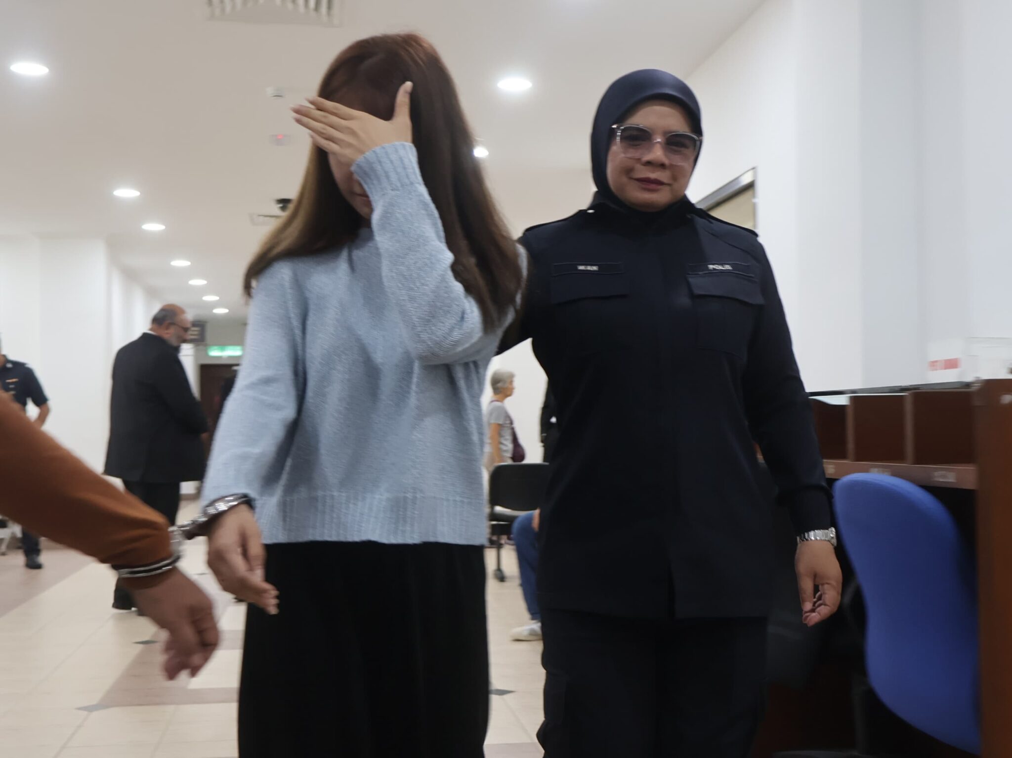 Sarah leo hiding face from reporters in court