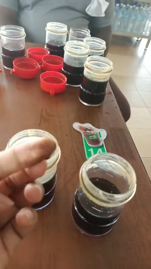 Woman showing what is suspected to be mold in the soy sauce container