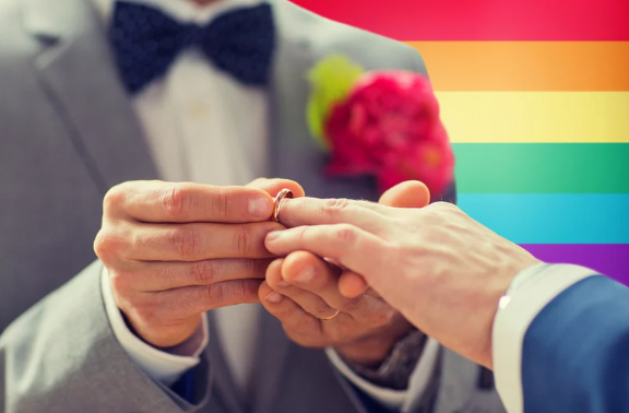 One man put a ring to his male partner finger