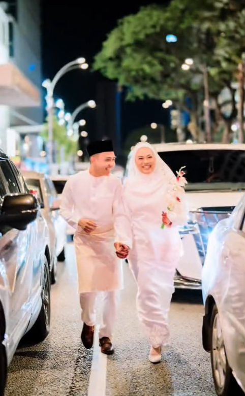 Newlyweds walking along bukit bintang zebra crossing