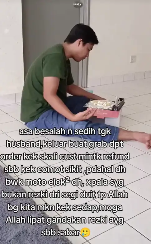 Msian man looking at his cake sorrowful