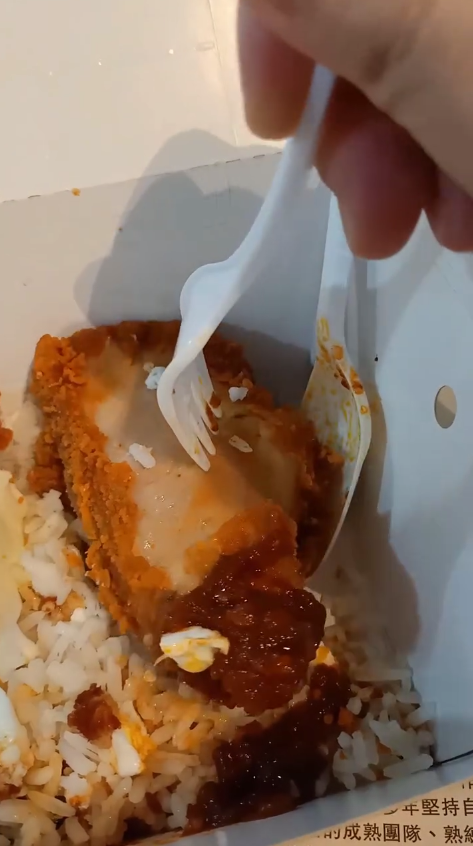 Msian suing his fork to poke the mcspicy chicken