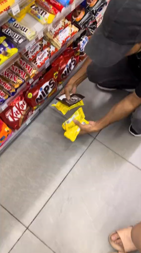 7-eleven's staff is checking the expiration dates on the chocolates after being pointed out by the customer.