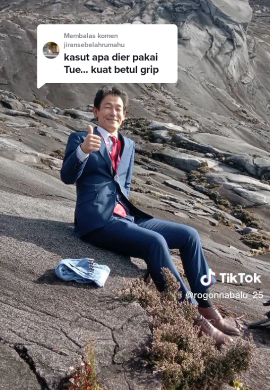 Japanese man climbs mt kinabalu in a suit to attend 'business meeting' | weirdkaya