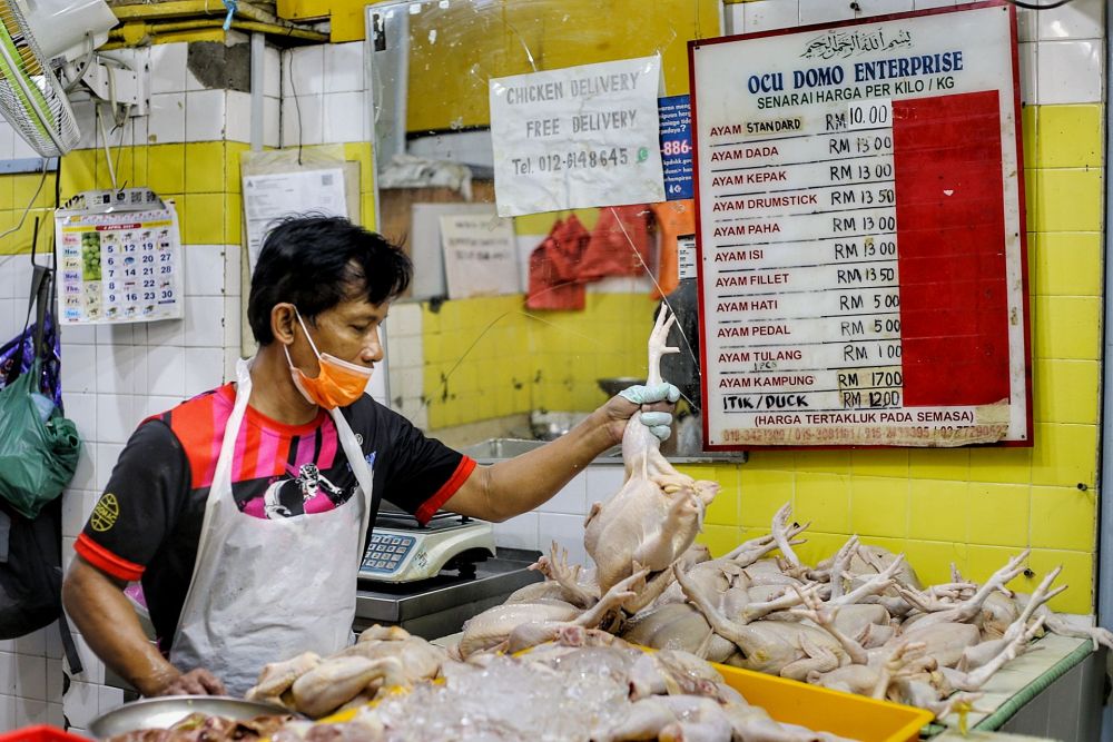 M'sian vendor selling chicken meat