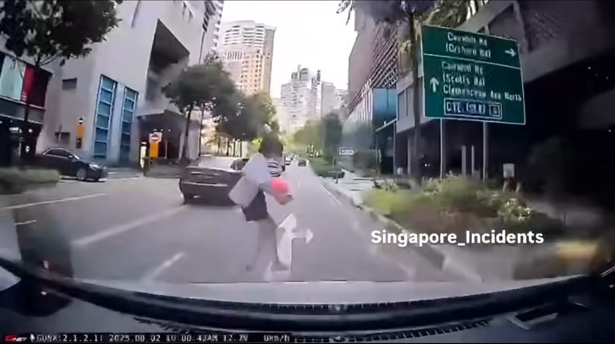 SG woman runs across the road