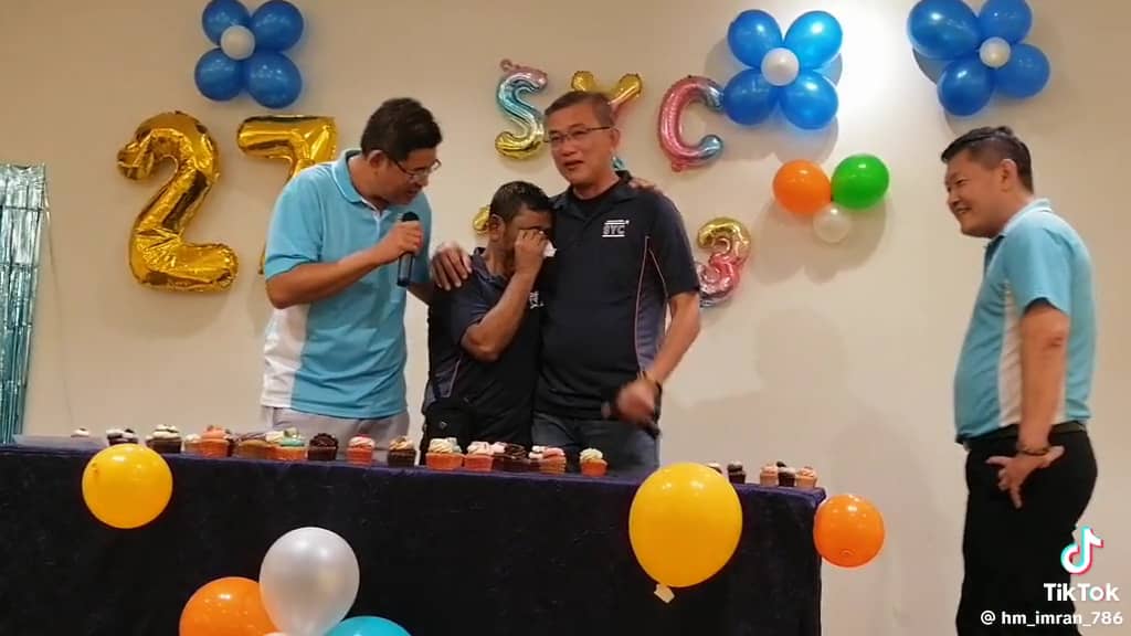 Singapore company honoring their worker at a farewell party