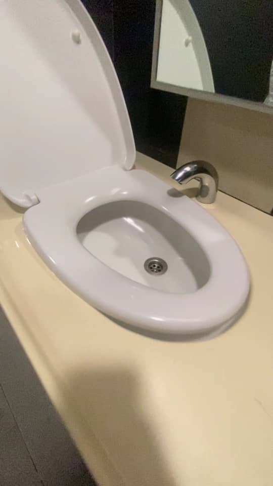 Sink in a washroom looking like a toilet bowl