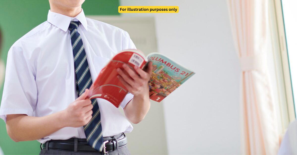 student holding a book