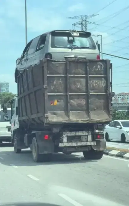 SUV on top of lorry