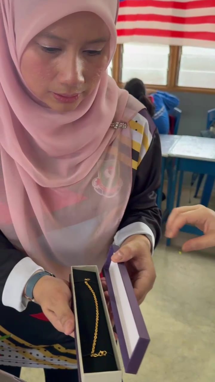 Teached stunned by the gift presented by her students