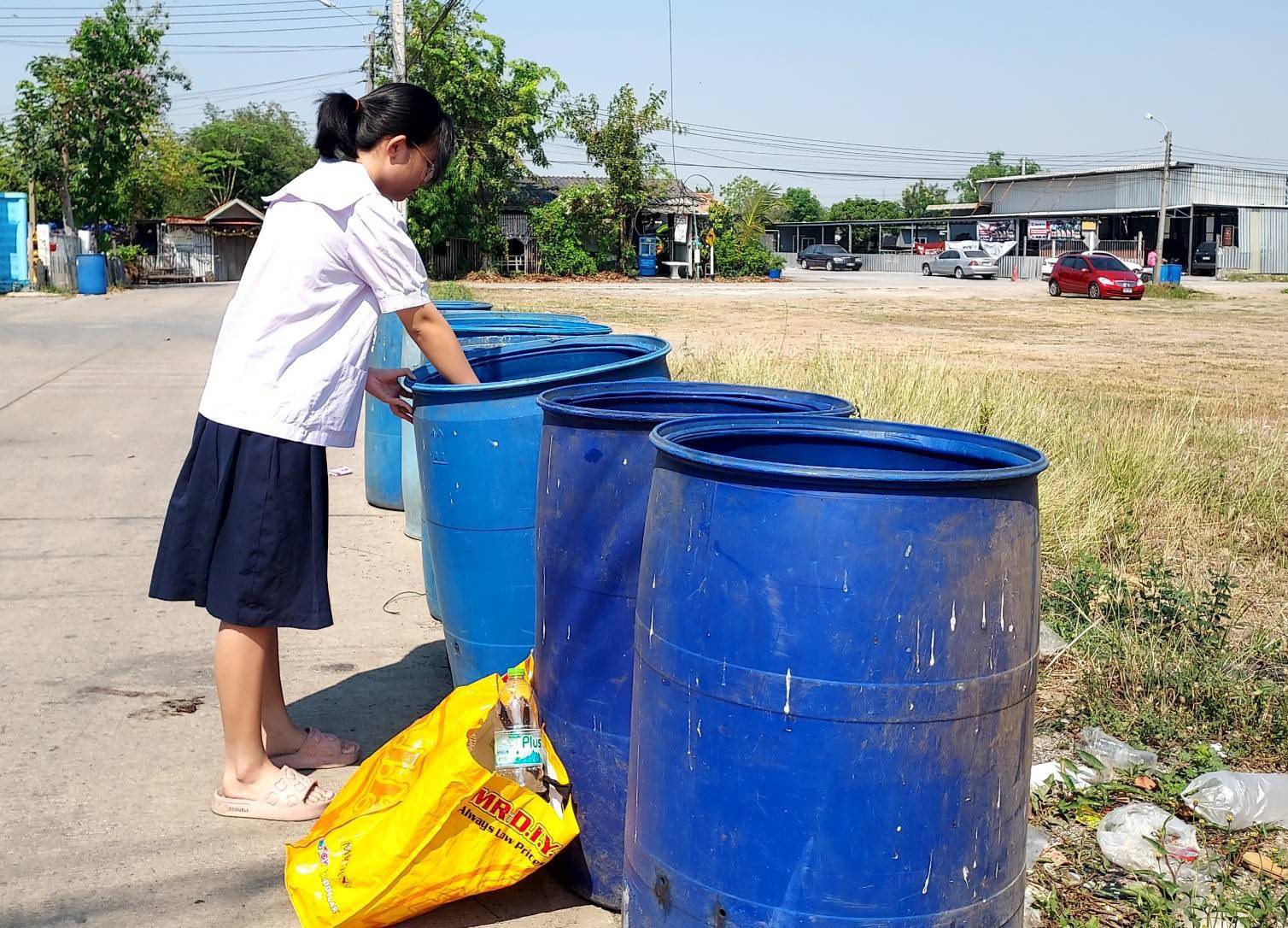 thai girl collecting bottles