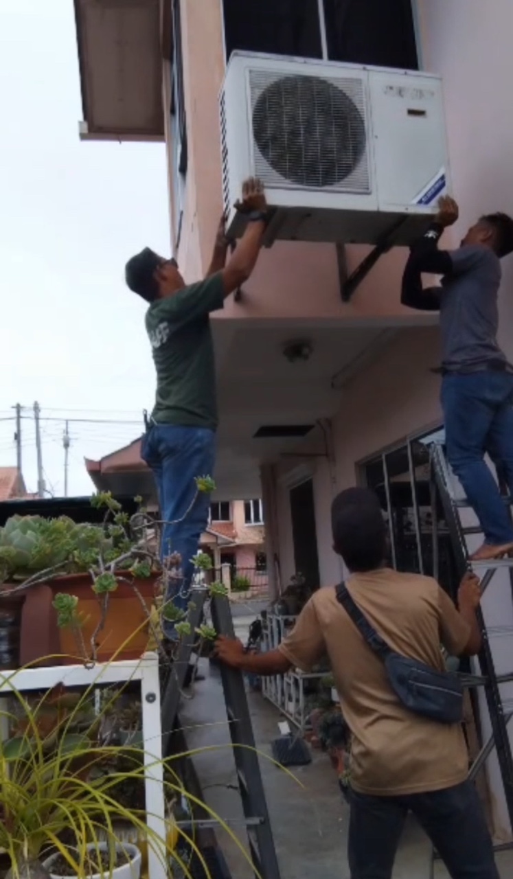 Three men removing air cond compressor