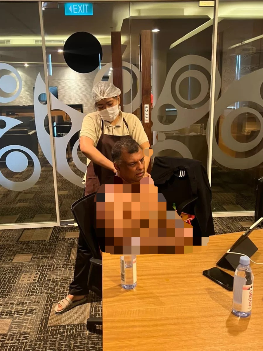 Tony fernandes goes shirtless while holding meeting