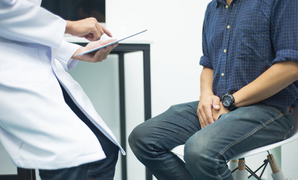 A man sitting and having a discussion with a doctor.