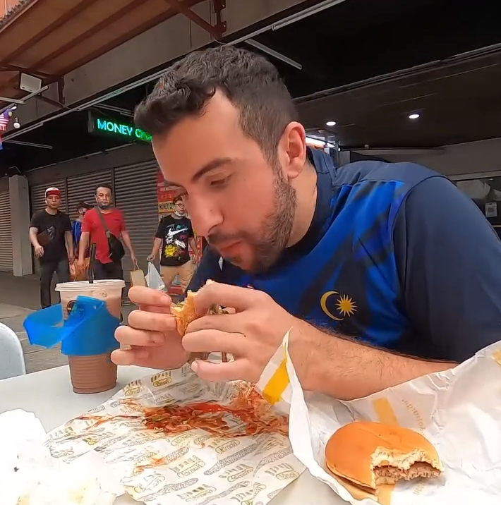 Tourist eating burger
