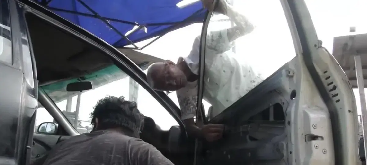 two men checking a car