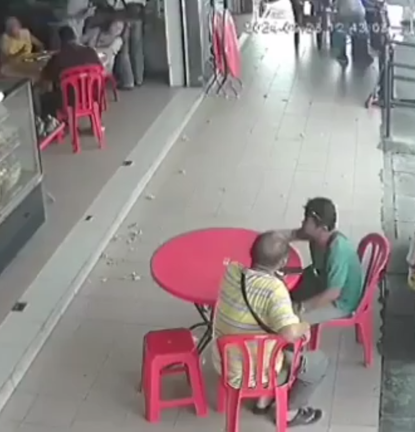 Two men sitting at a kopitiam