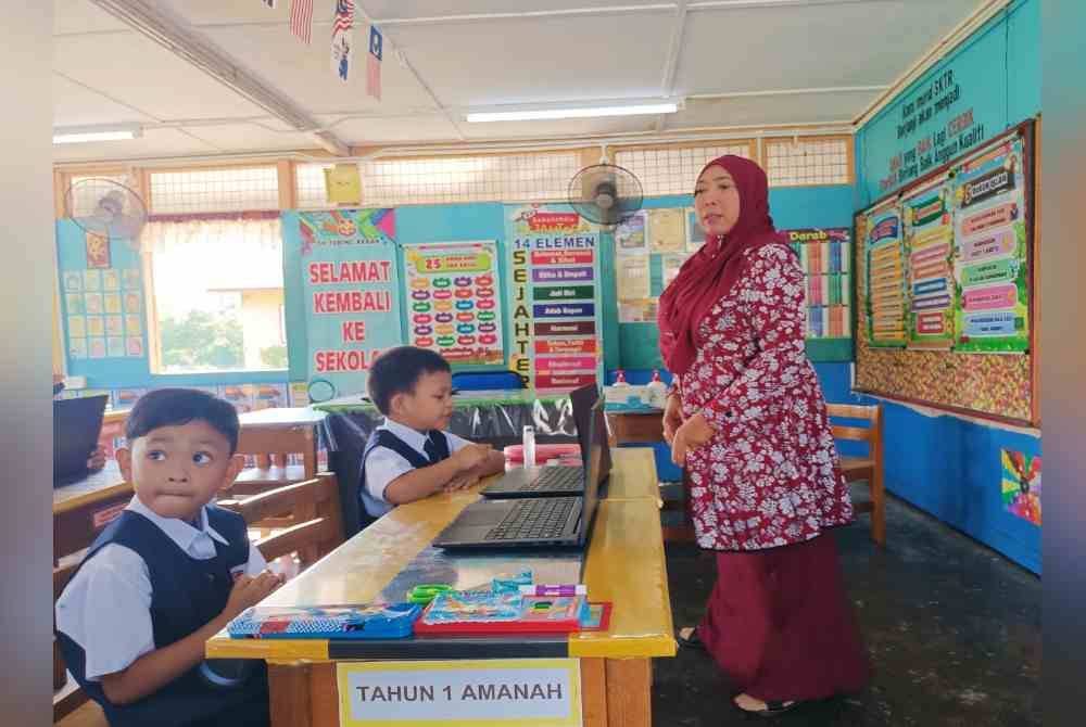 Two new students sitting in the class with a teacher