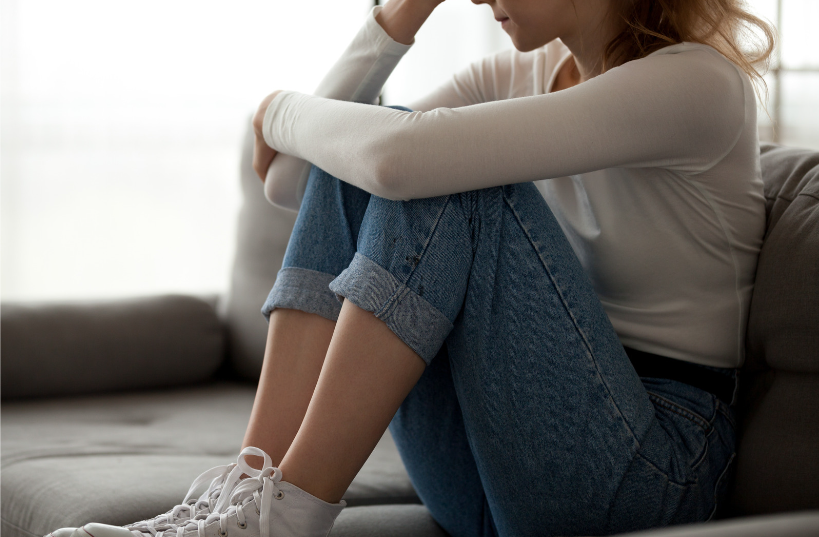 Upset woman sitting on the couch