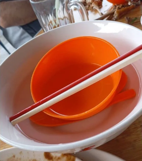 Utensils being washed in hot water